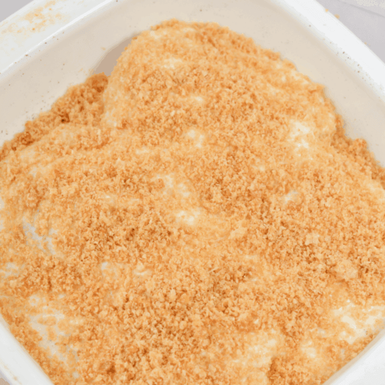 Placing coated chicken thighs in air fryer basket spaced apart