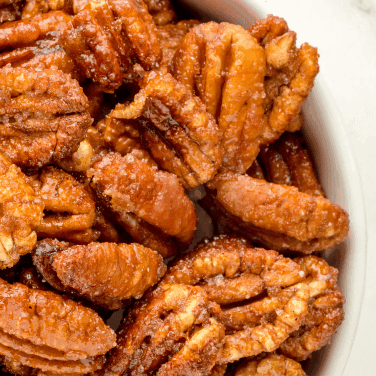 Air fryer gingerbread candied pecans coated in warm holiday spices.