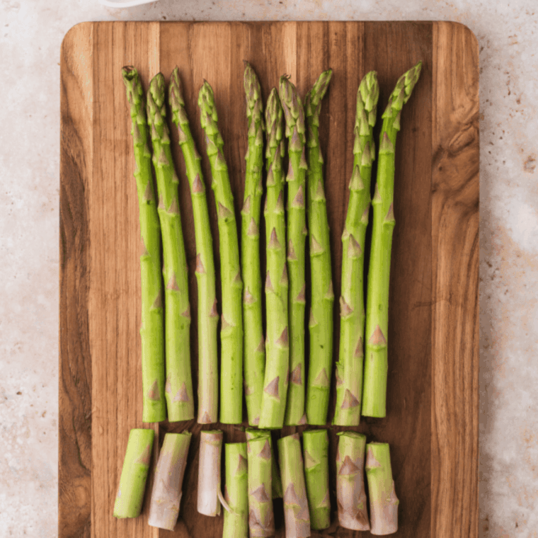 Preheating air fryer to 375&deg;F while trimming woody ends from asparagus spears.