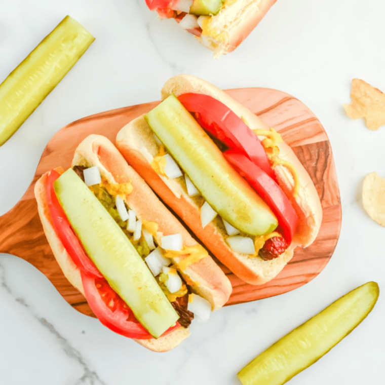 Chicago-style hot dog made in the air fryer, topped with mustard, relish, tomato, pickles, sport peppers, and celery salt on a poppy seed bun.