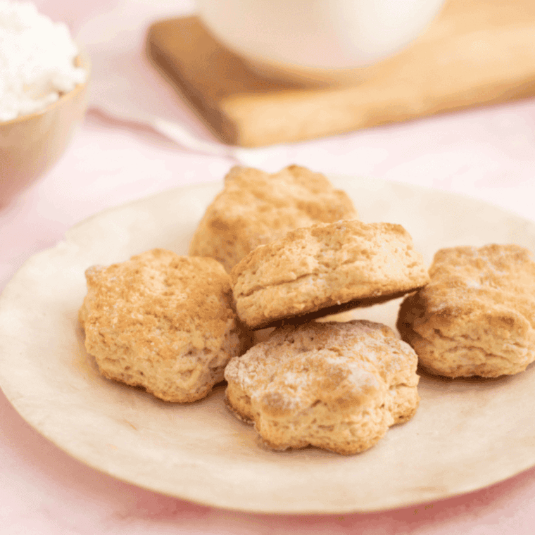 A plate of Air Fryer Lemonade Scones topped with jam and butter.