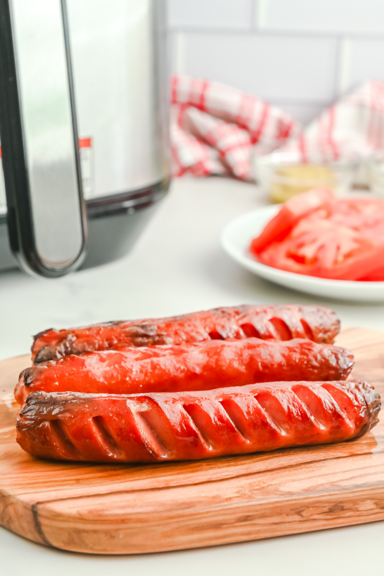 Finished hot dogs topped and served immediately in buns.