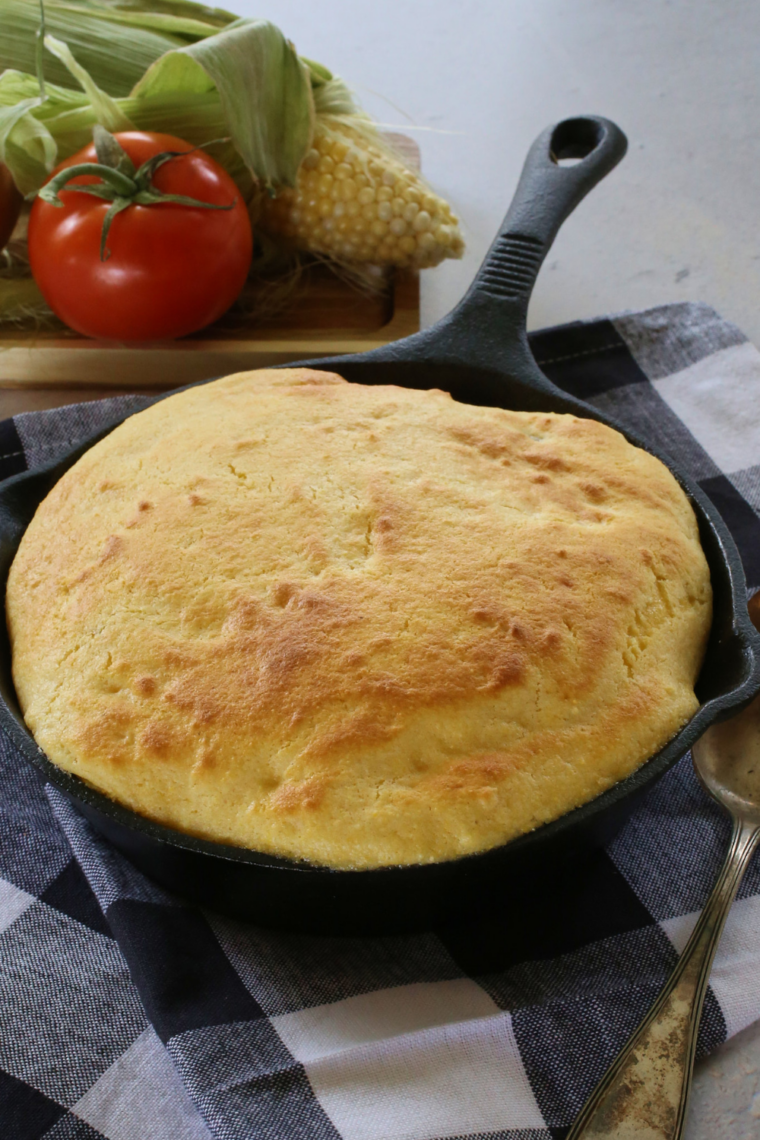 Overhead view of baked chili pie with cornbread topping in a cast iron skillet