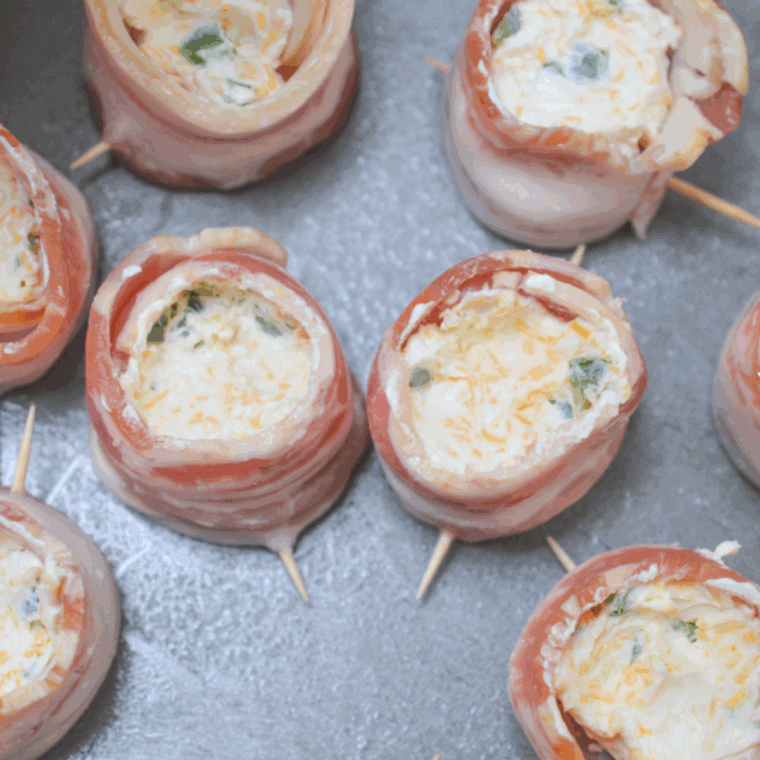 Filling bacon-wrapped sausage cups with a cream cheese, cheddar, and BBQ seasoning mixture.