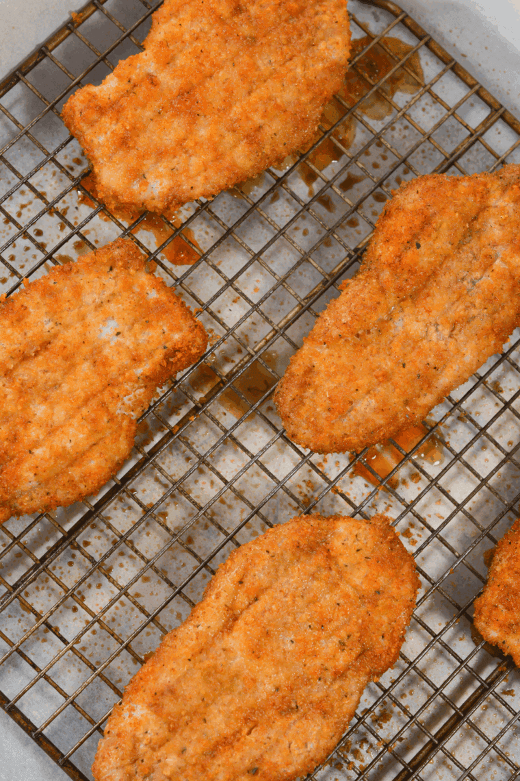 Golden breaded Bob Evans-style pork chop cooked to perfection, served with parsley garnish.
