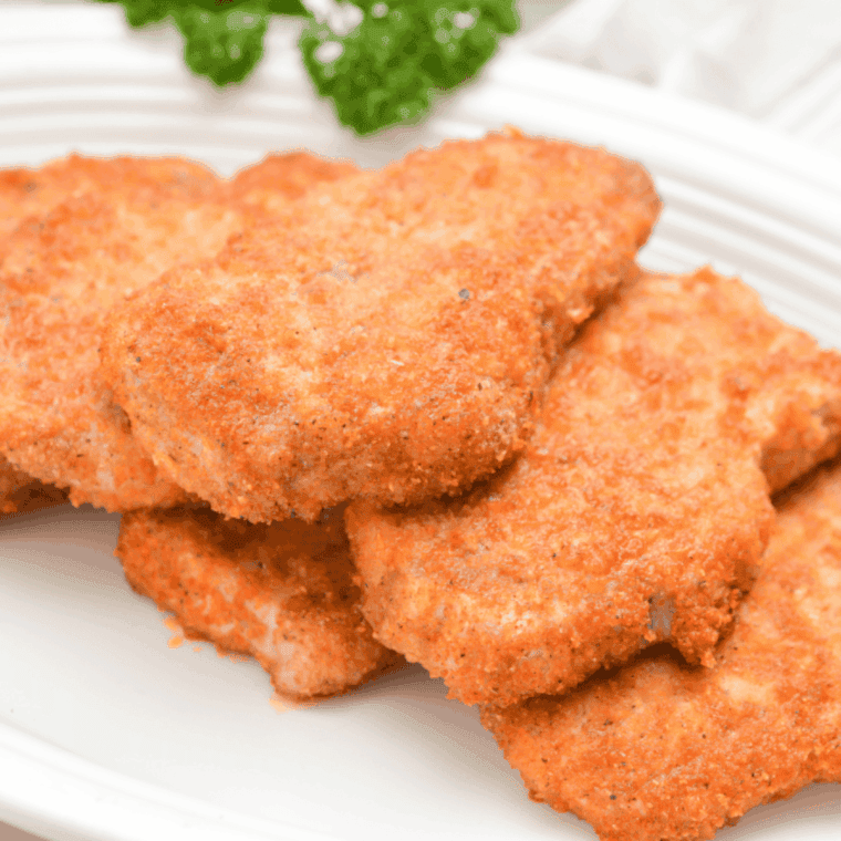 Golden breaded Bob Evans-style pork chops served with parsley garnish.