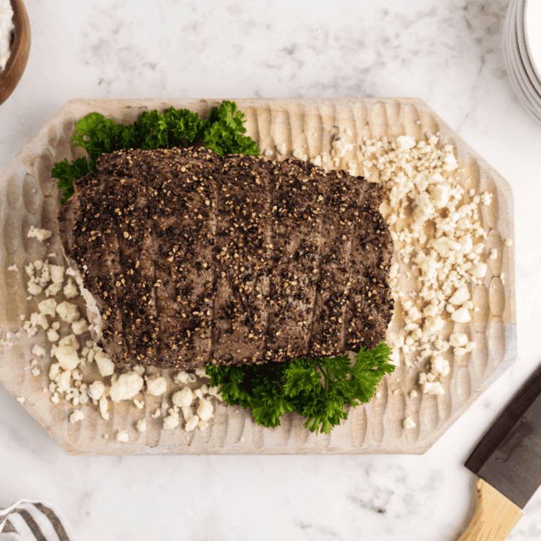 Air fryer blue cheese stuffed flank steak sliced, showing gooey melted cheese inside