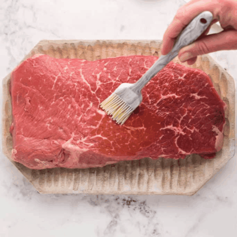 Flank steak prepped with olive oil and soaked cooking twine for air fryer recipe