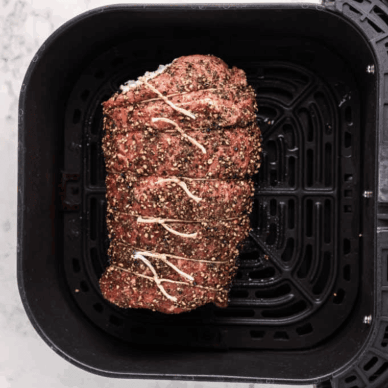 Preheating air fryer to 375°F with basket lightly sprayed for cooking steak roll