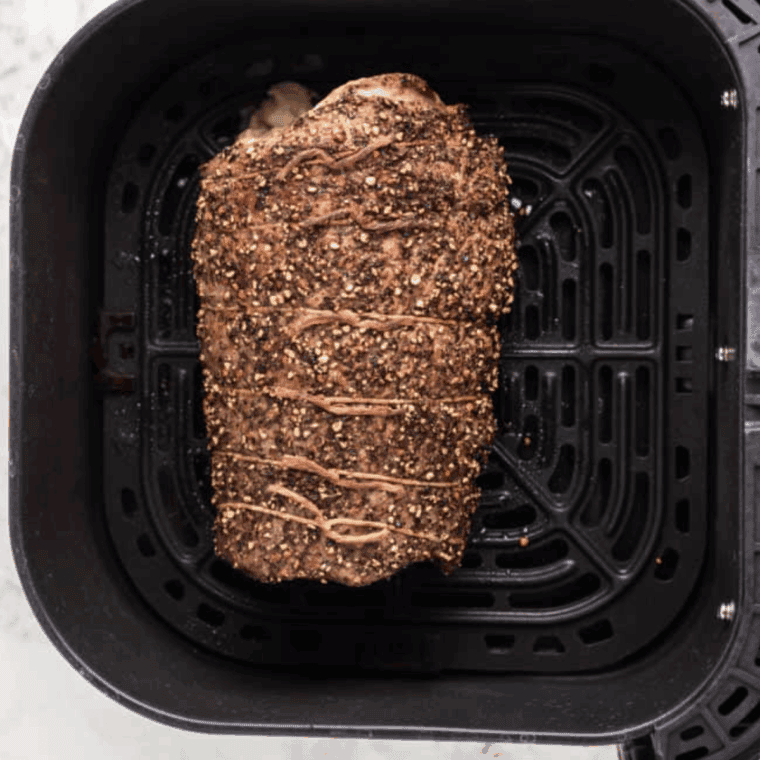 Air fryer blue cheese stuffed flank steak cooking, resting, and sliced into serving portions