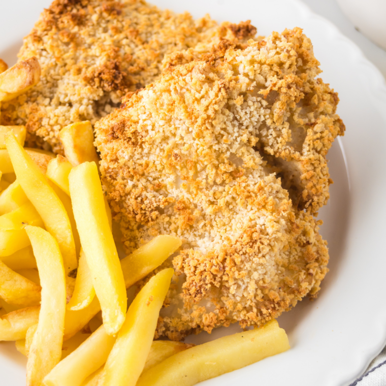 Instant-read thermometer showing 145°F in a baked fish fillet