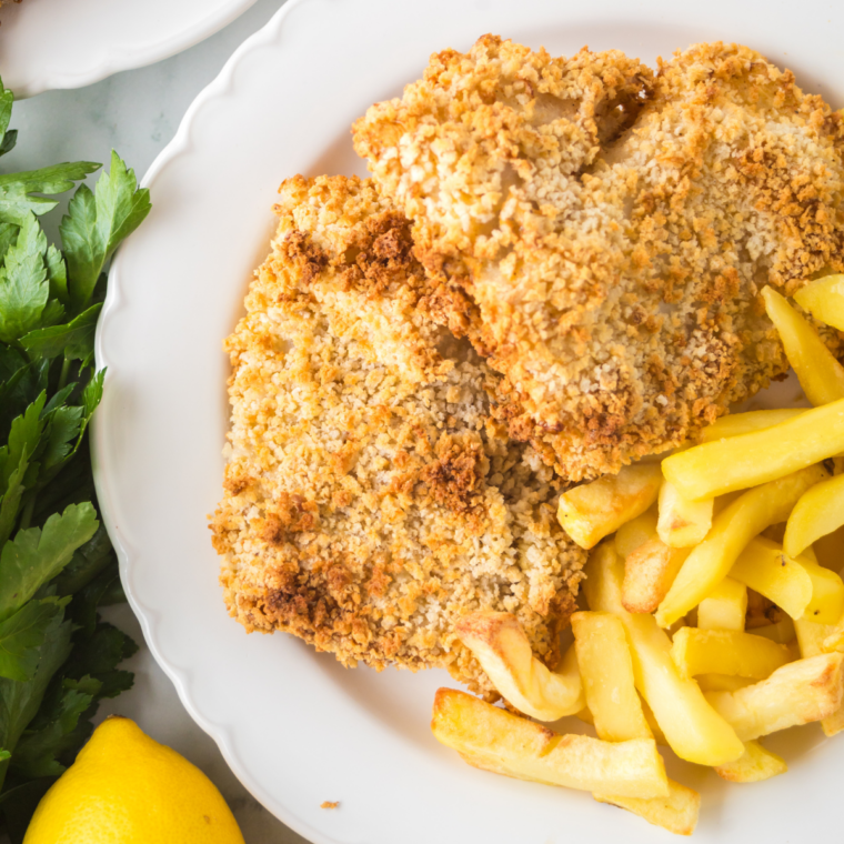 Parmesan-crusted and Cajun-seasoned baked fish fillets side by side