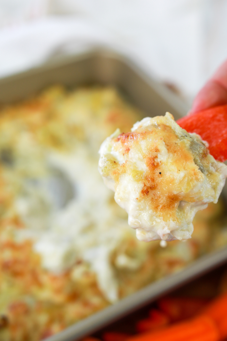 Creamy air fryer artichoke dip with a golden top served with pita chips