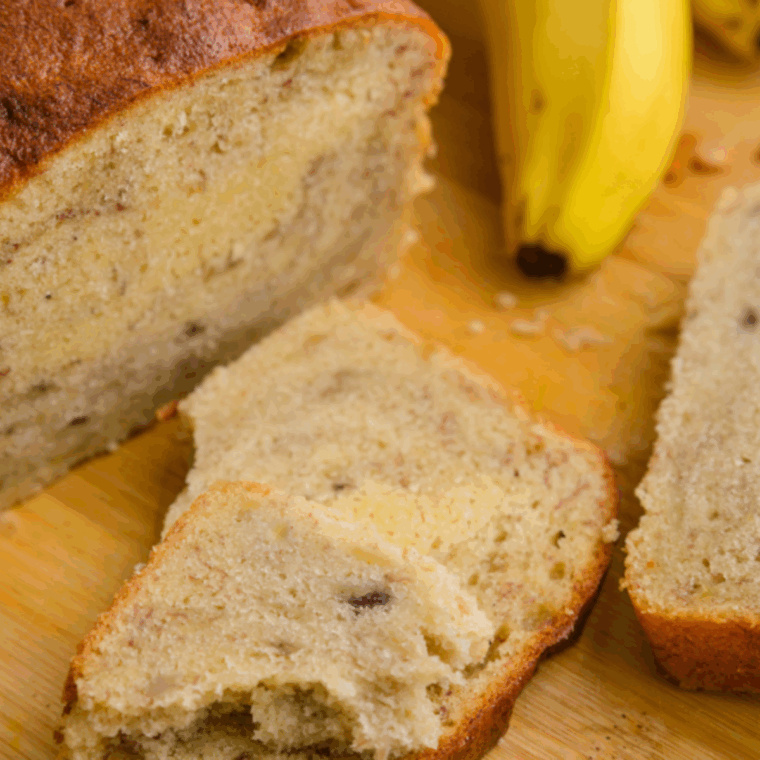 Golden, freshly baked banana bread in a Ninja air fryer, sliced and ready to serve