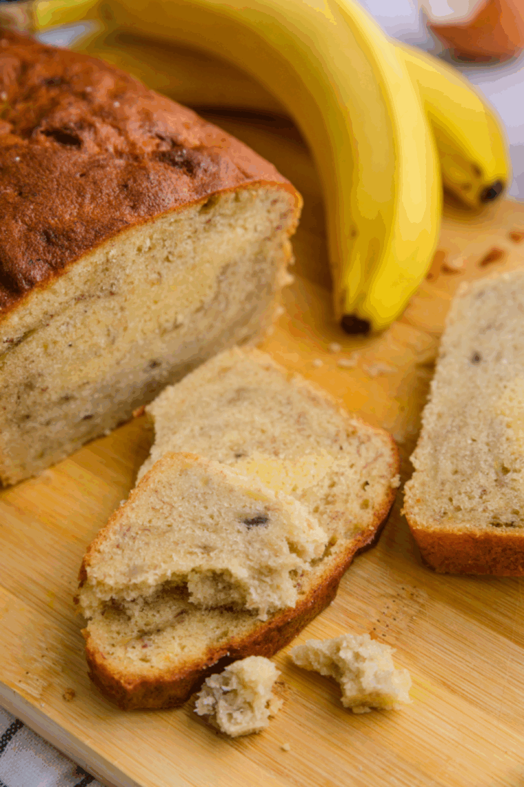 Freshly baked golden banana bread in a Ninja air fryer, sliced and ready to serve