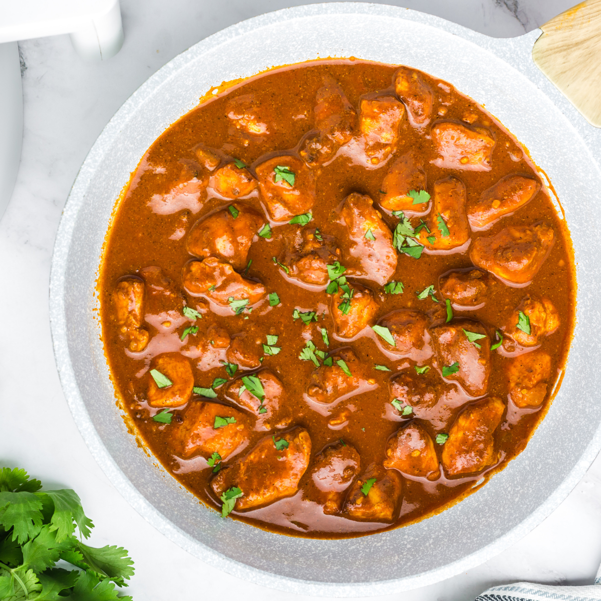 Air Fryer Chicken Vindaloo with tender, spiced chicken served with a flavorful curry sauce and garnished with cilantro.