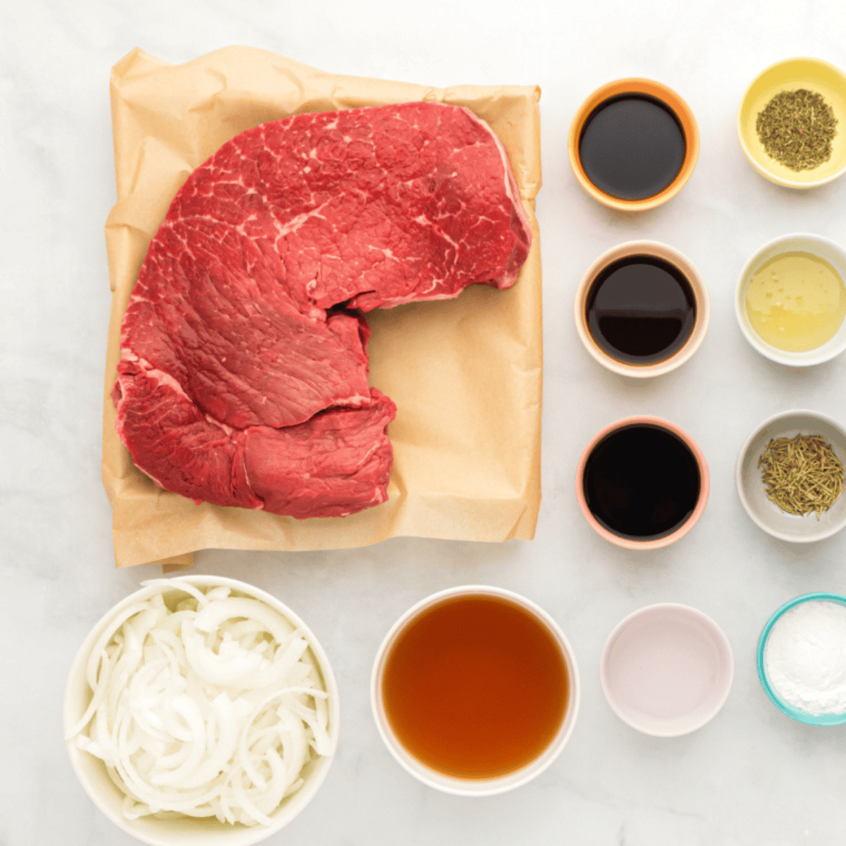 Ingredients needed for Easy Slow Cooker Flank Steak on kitchen table.