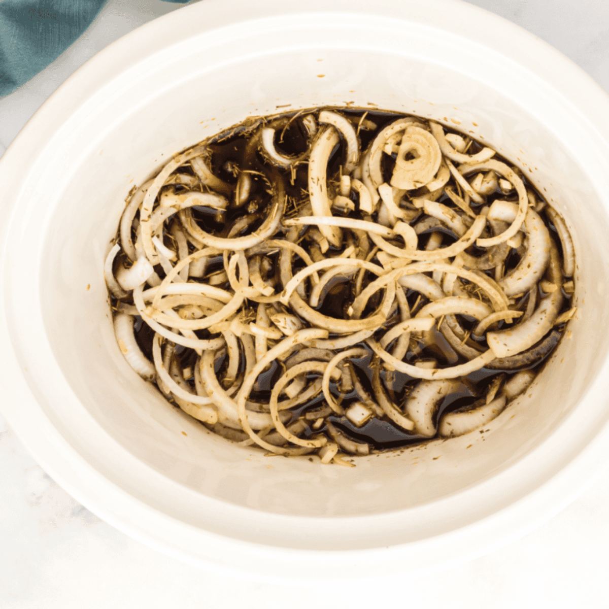 Sautéing sliced onions and minced garlic in a skillet with oil over medium heat..