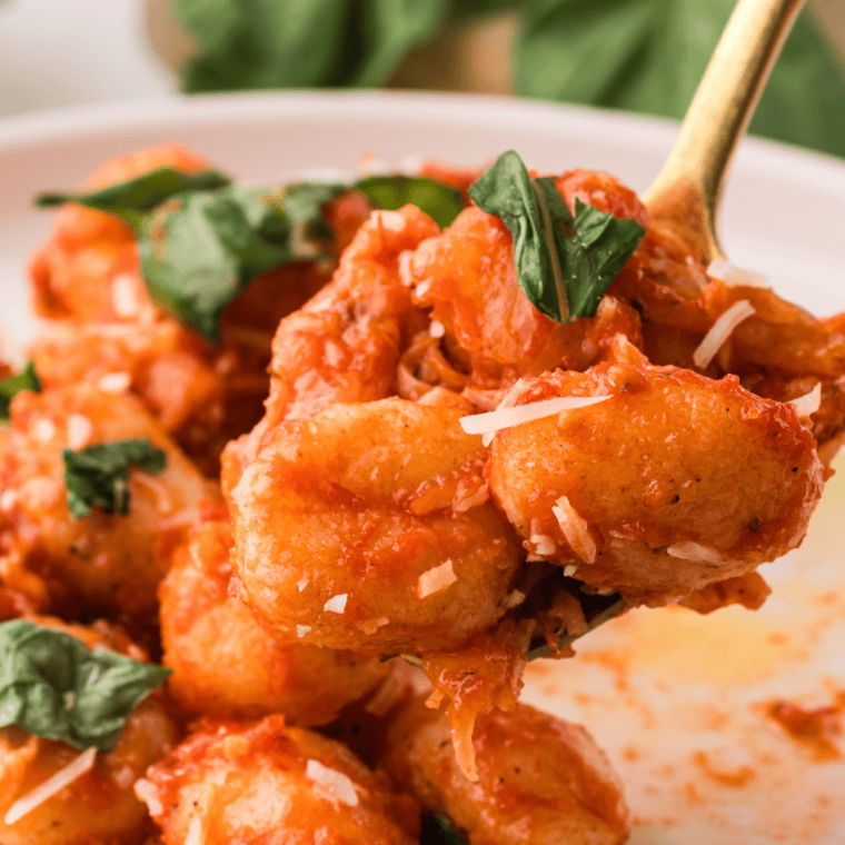 Baked Gnocchi Alla Sorrentina with tomato sauce, mozzarella, and fresh basil.