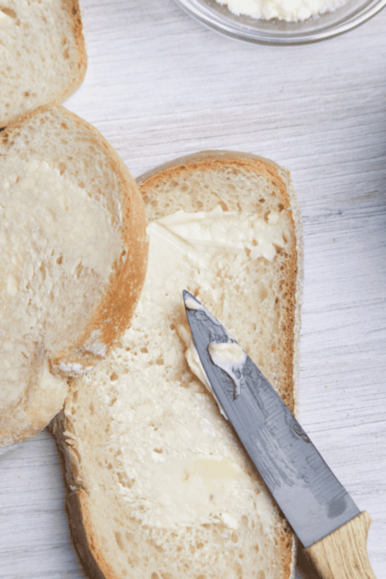 Italian bread slices brushed with butter and olive oil, ready for air frying