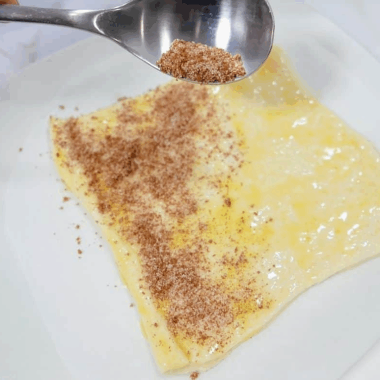 Brush the cinnamon on top of the melted butter.