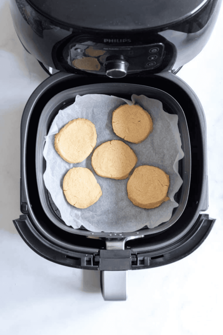 Cooked cookies in the air fryer basket.