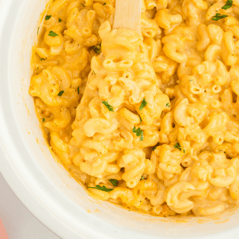 Crockpot overflowing with creamy Jason’s Deli copycat mac and cheese