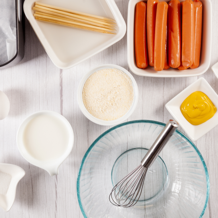 Ingredients needed for Homemade Corn Dogs In Air Fryer on kitchen table.