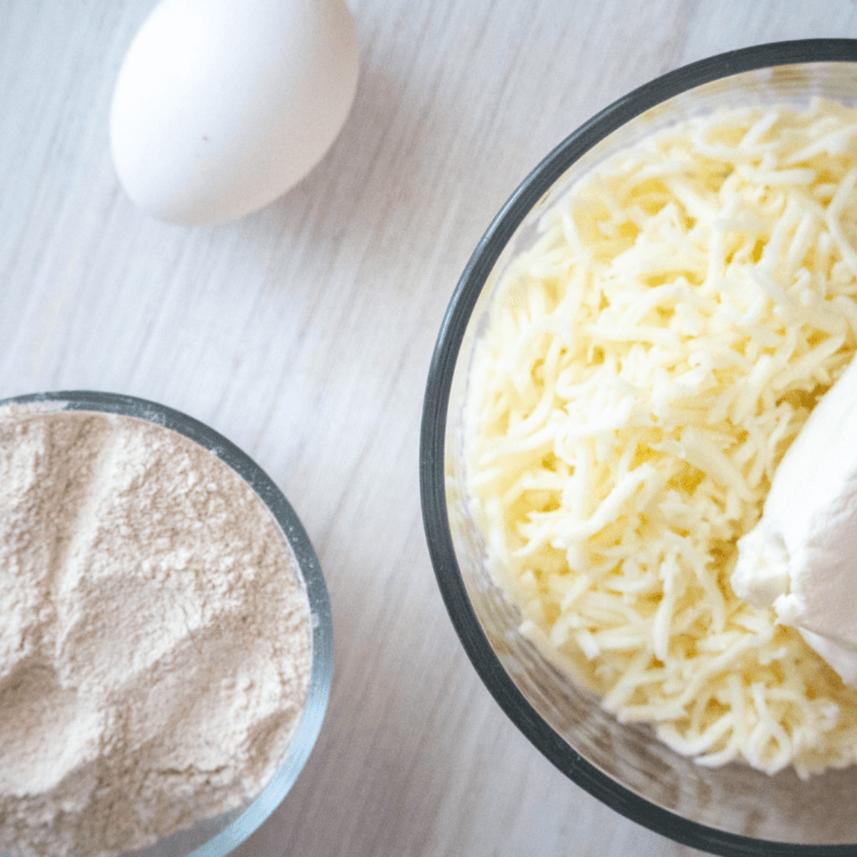 Mozzarella and cream cheese melted together in a medium microwave-safe bowl.