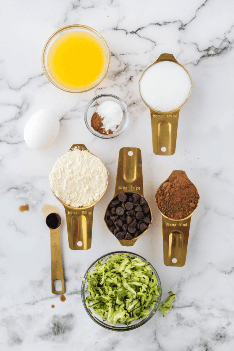 Ingredients needed for Air Fryer Chocolate Chip Zucchini Bread on kitchen table.