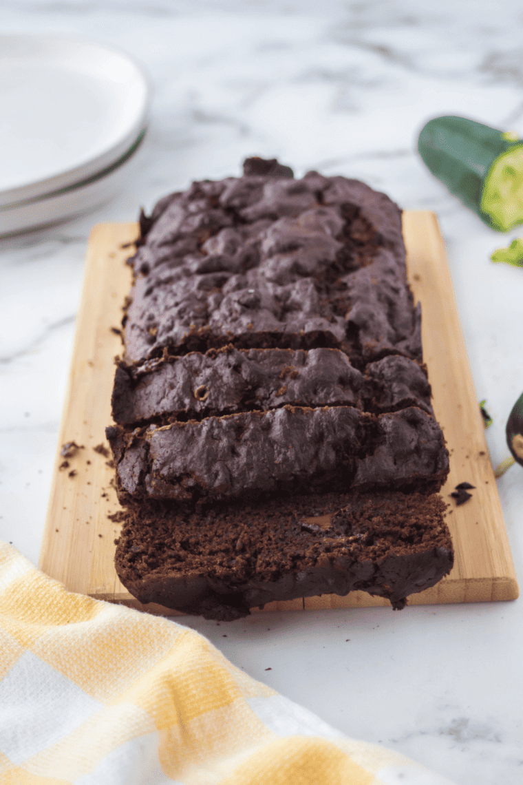 Freshly baked chocolate chip zucchini bread in an air fryer-safe pan, golden brown with melted chocolate chips.