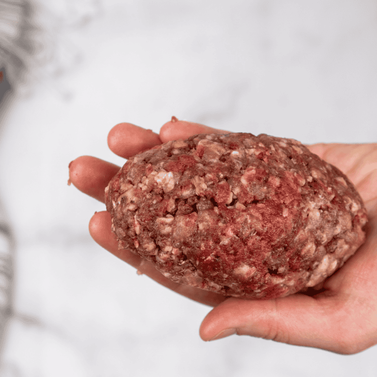 Wrapping the meat around the pepper and cheese.