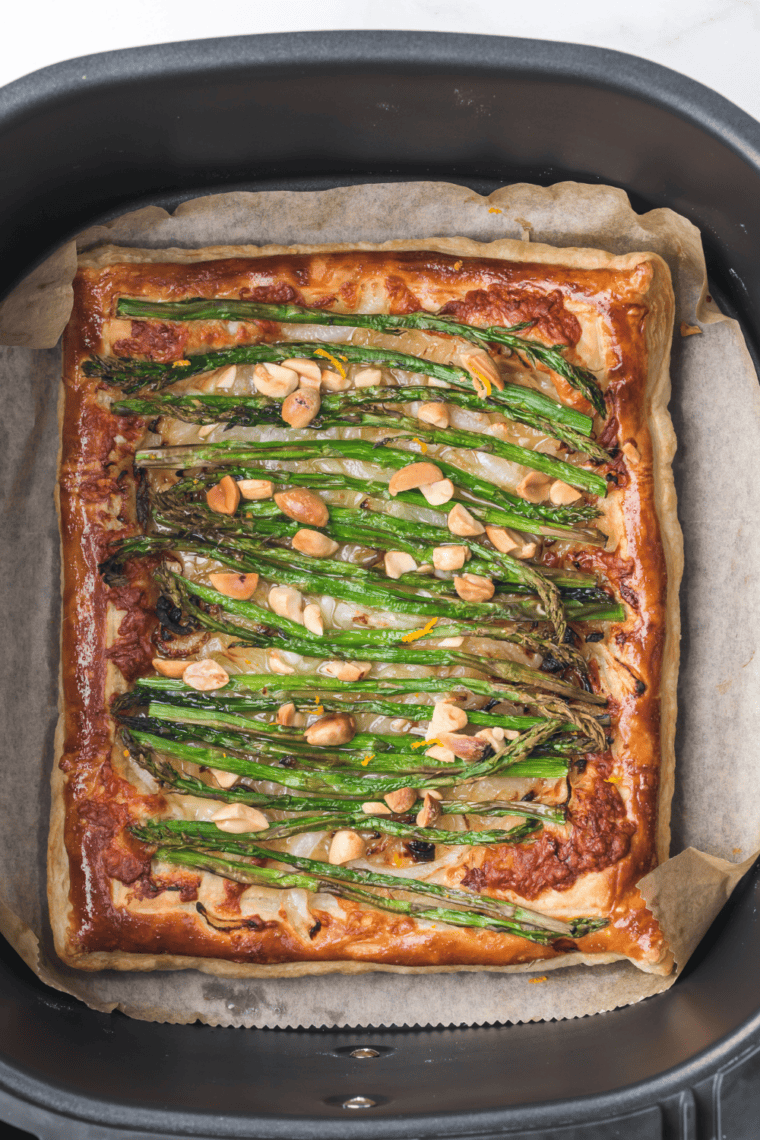 Cooked  Asparagus Tart in the air fryer basket.