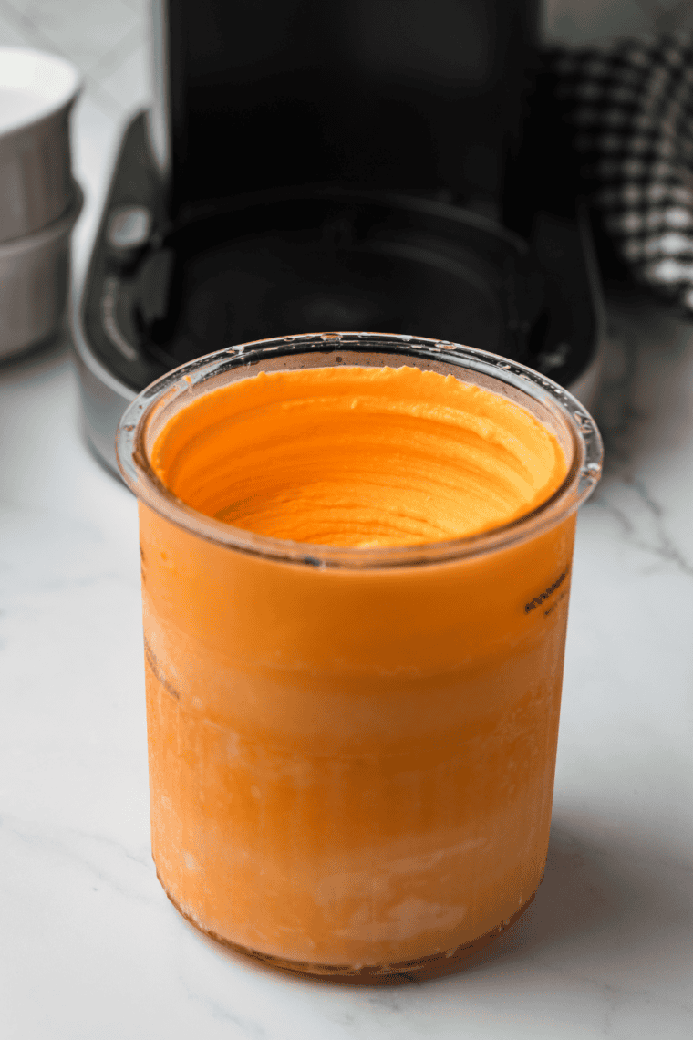 Ninja Creami orange creamsicle Italian ice scooped into dessert bowl.