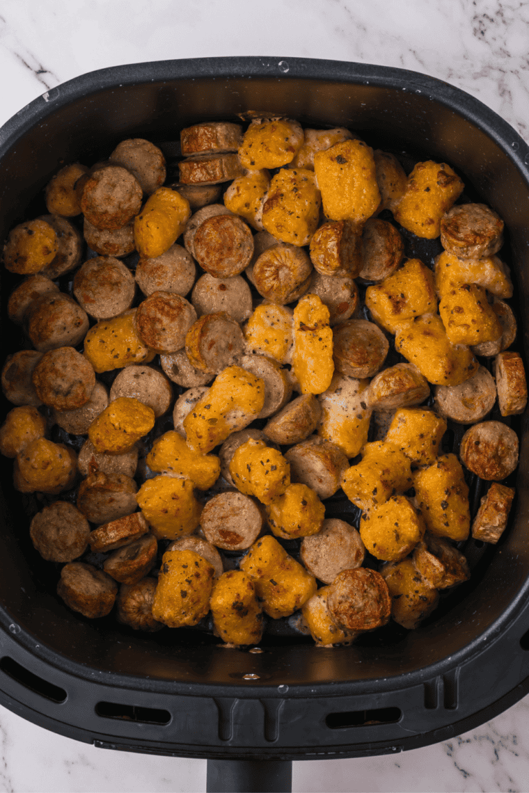 Golden brown crispy sweet potato gnocchi finished cooking in the air fryer basket