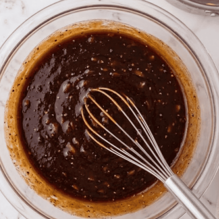 Whisking mayonnaise, barbecue sauce, and ketchup in a bowl for chipotle BBQ sauce