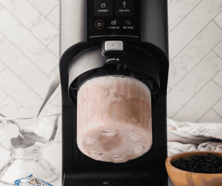 Frozen pumpkin pie shake pint locked into the Ninja Creami running the Milkshake function