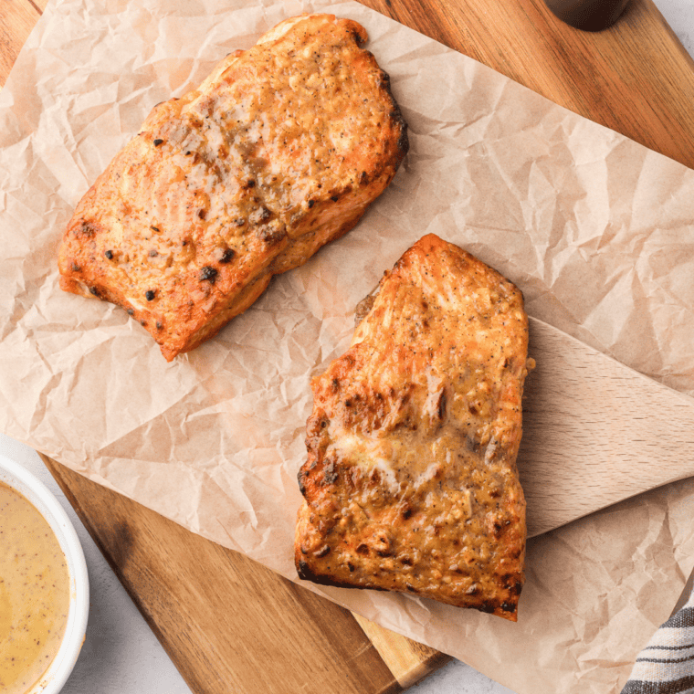 Marinated salmon fillet in an air fryer basket ready to cook