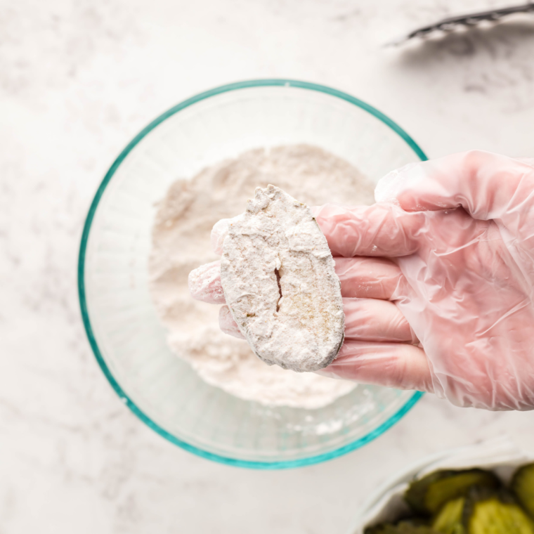 Shallow bowl of seasoned flour and cornstarch for coating pickle chips