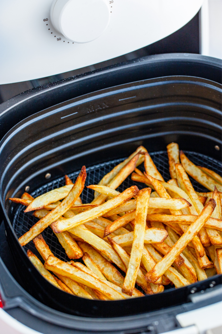 Close-up of golden, ultra-crispy air fryer beef tallow fries sprinkled with sea salt