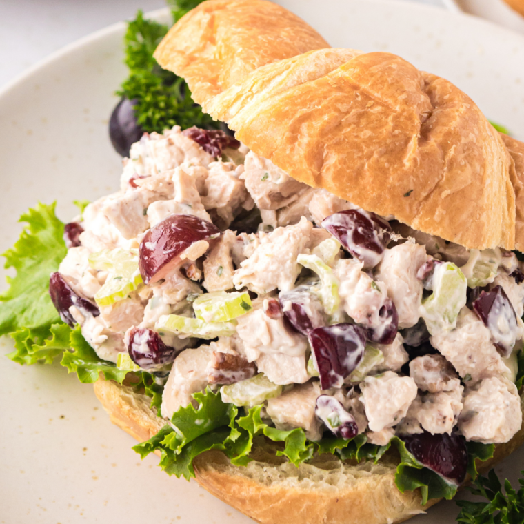 Mini cranberry pecan chicken salad sliders on Hawaiian rolls on a serving platter