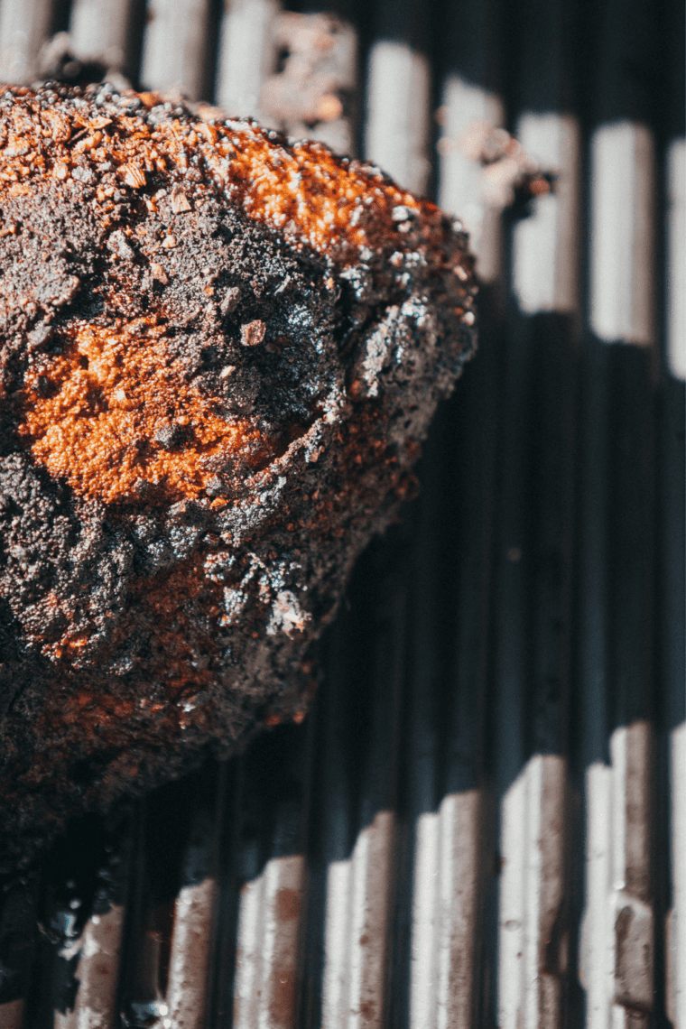 Separating the point from the flat of a smoked brisket along the fat seam