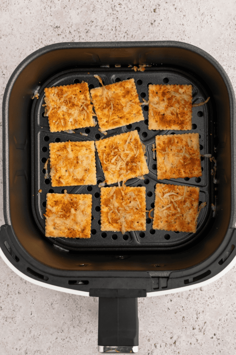 Ranch seasoned saltine crackers in a single layer in an air fryer basket