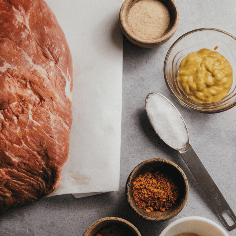 Ingredients for brisket rub: coarse sea salt, coarse black pepper, cumin, turmeric, granulated garlic, granulated onion, chili powder, and sugar