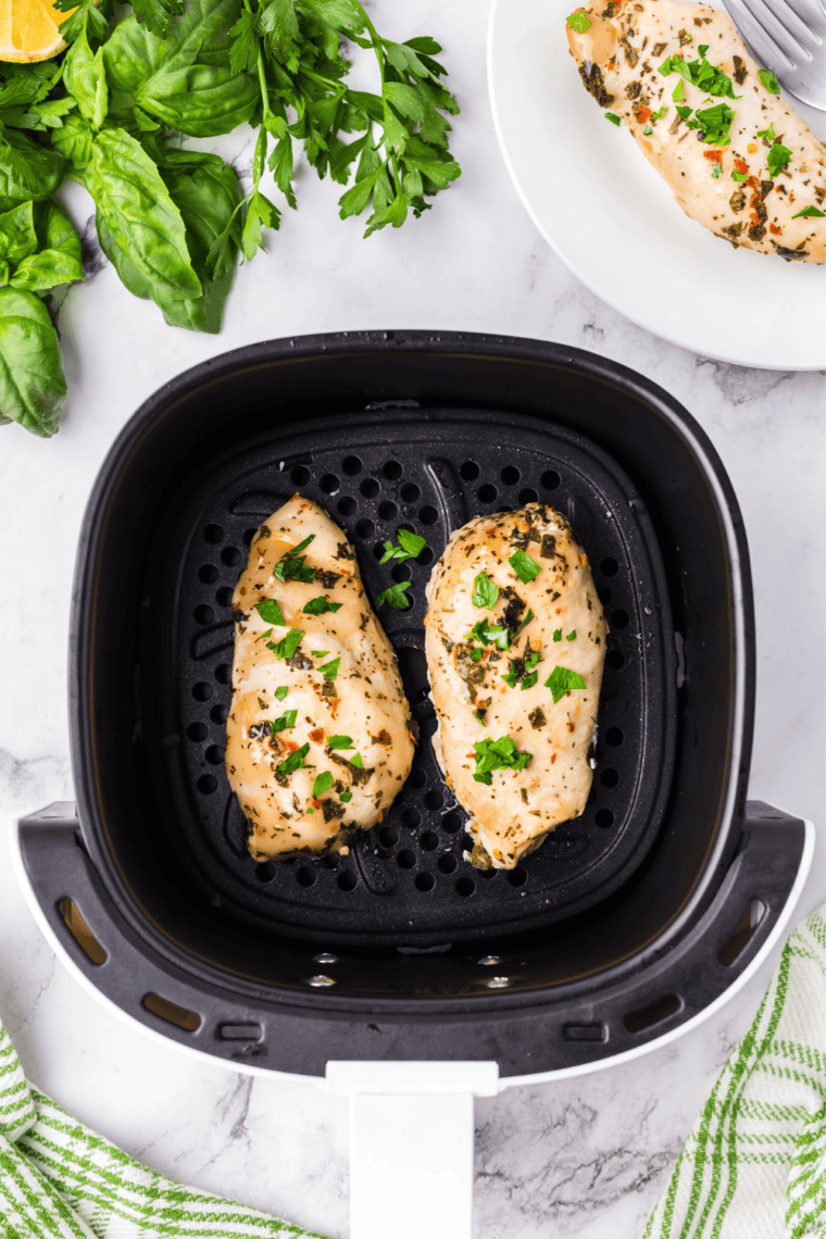 Air fryer Tuscan grilled chicken brushed with herb butter baste in the basket