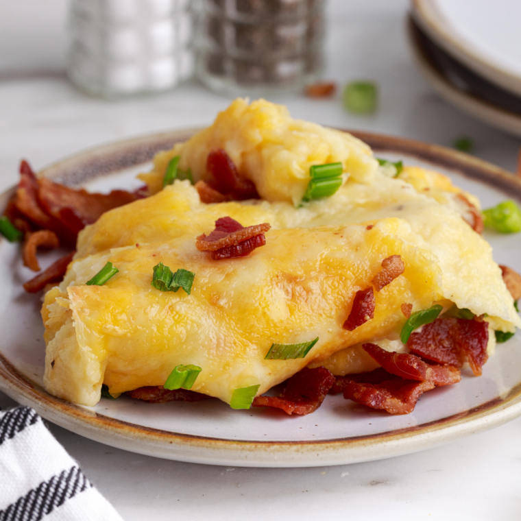 Loaded copycat Culver's mashed potatoes topped with melted cheddar cheese and crispy crumbled bacon