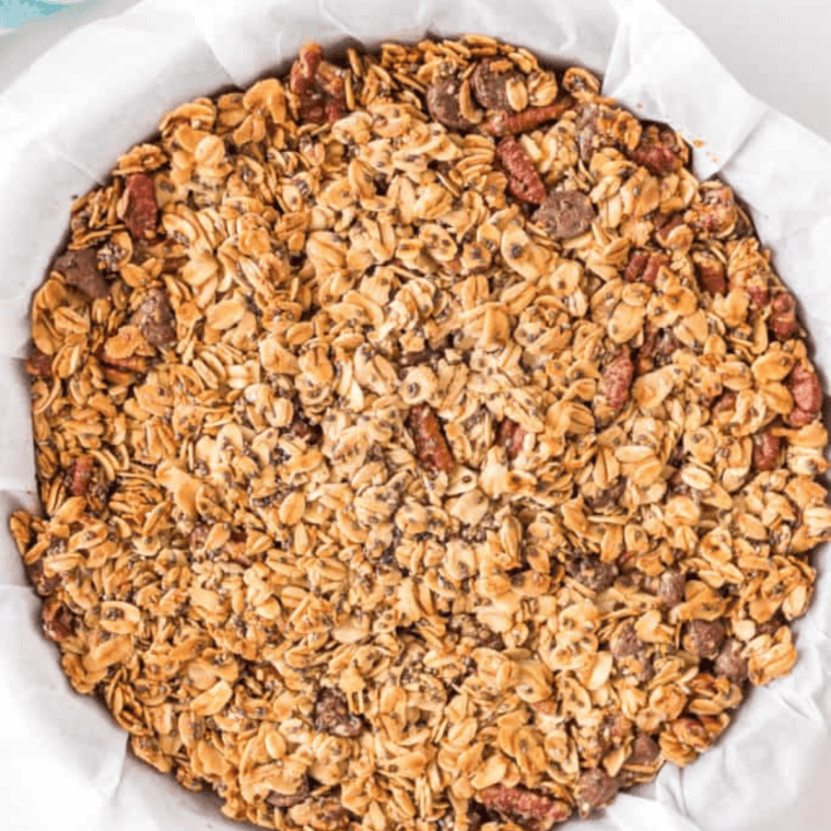 Golden brown baked protein granola slab cooling on a sheet pan