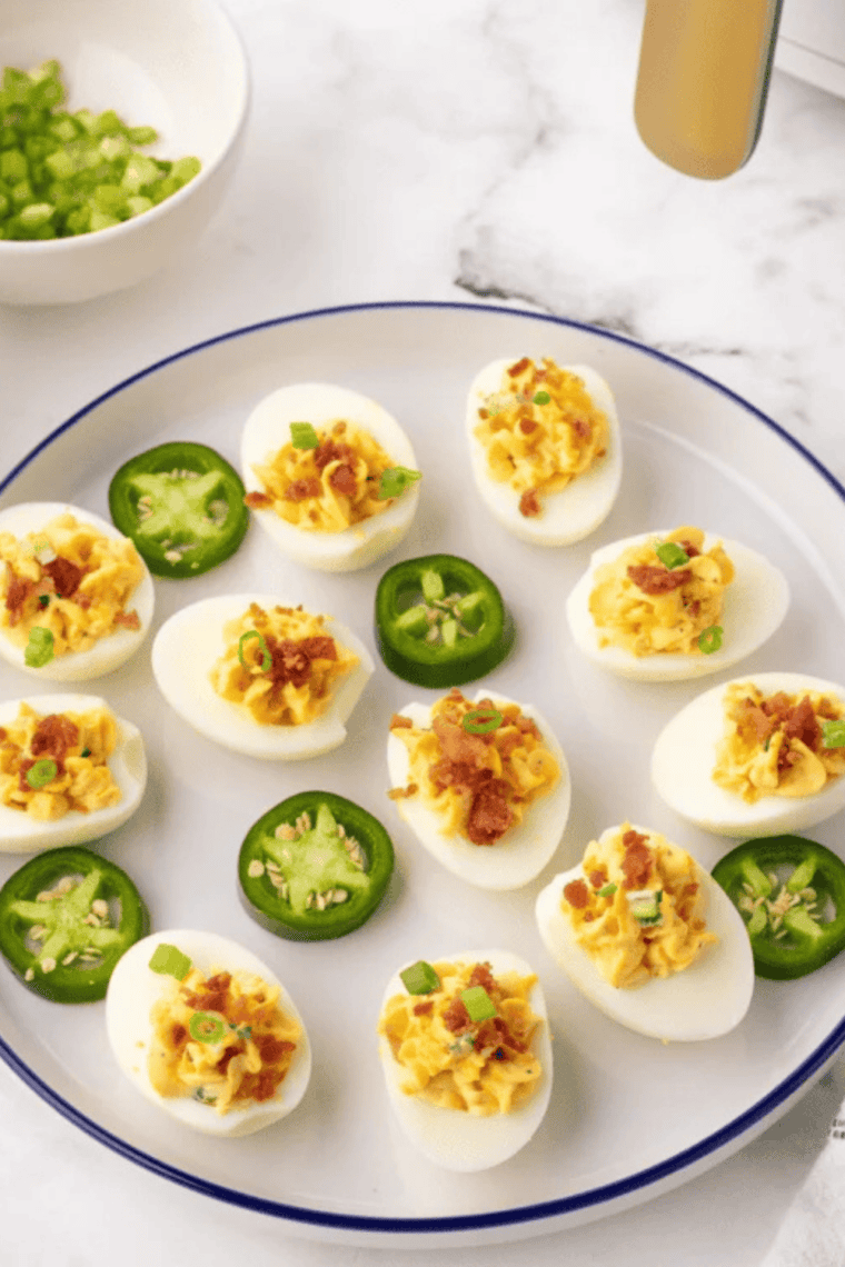 Close-up of a Southern deviled egg topped with paprika, chopped sweet pickle, and pimento