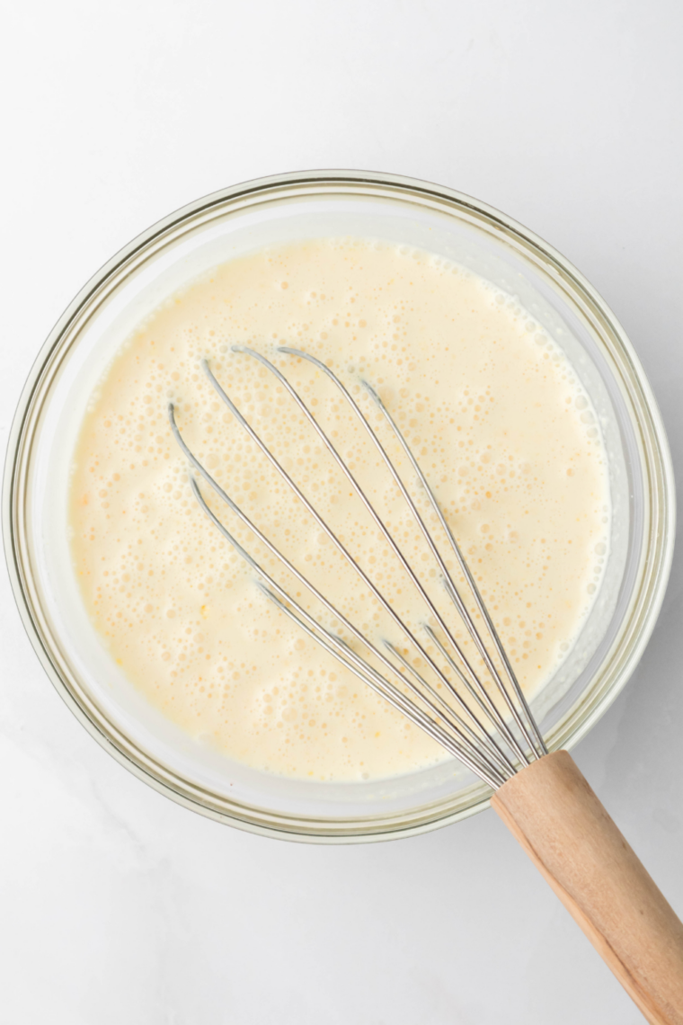 Cream cheese, sugar, and vanilla whisked together in a glass bowl