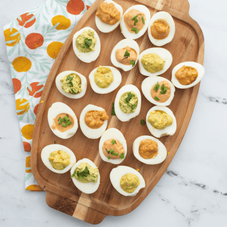 Paula Deen deviled eggs with sweet pickle relish, paprika, and pimentos on a white platter